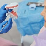 Dental explorer attracting attention to implant in teeth model